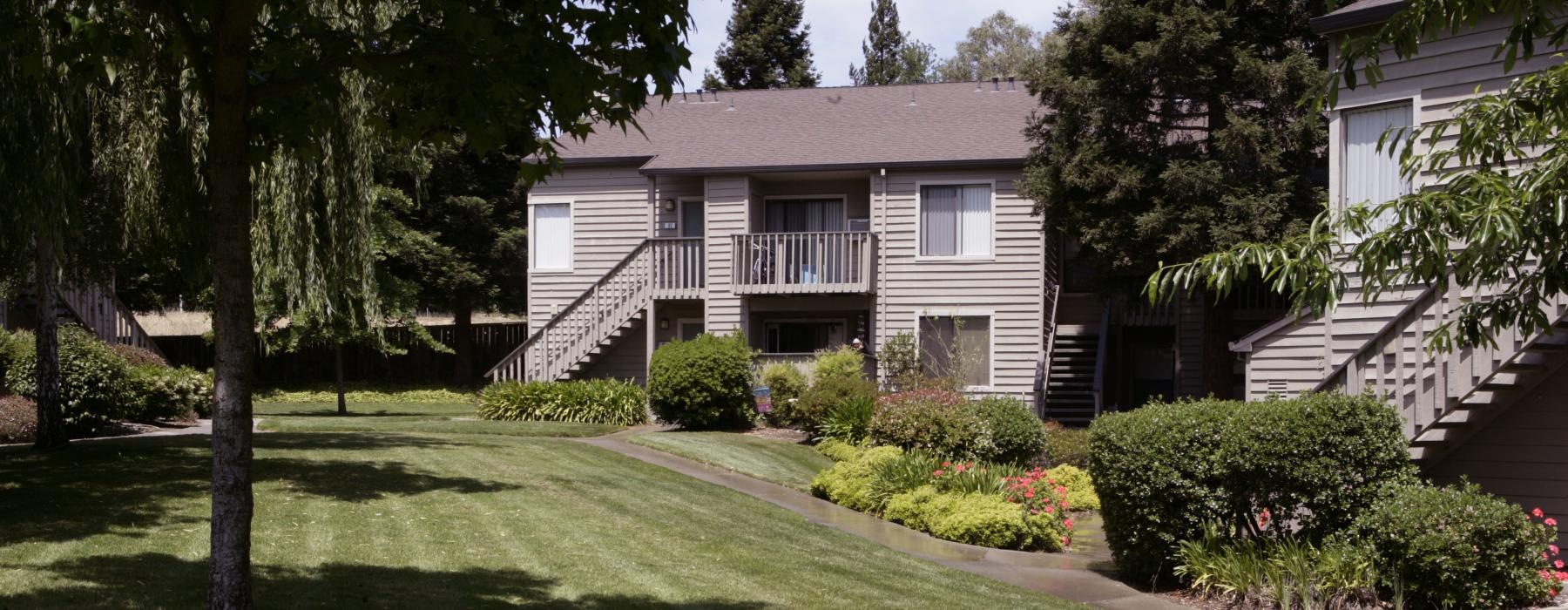 a house with a lawn and trees